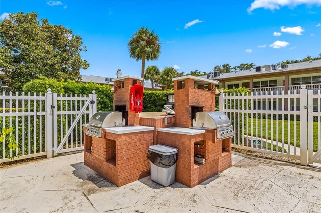 view of patio featuring an outdoor kitchen and a grill