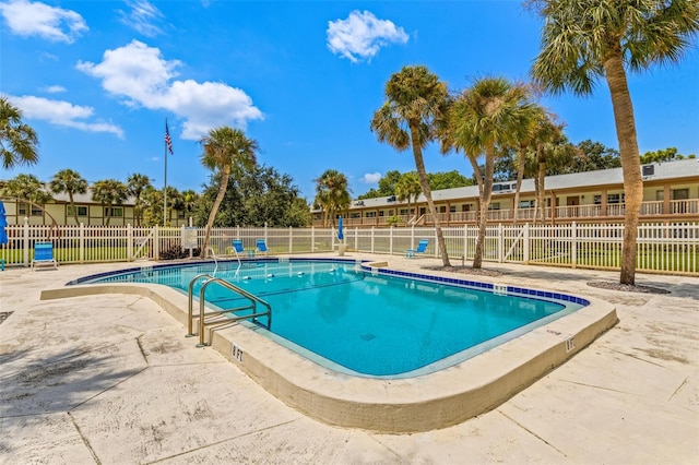 pool featuring fence and a patio