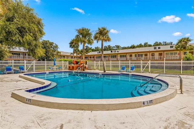 view of pool featuring fence