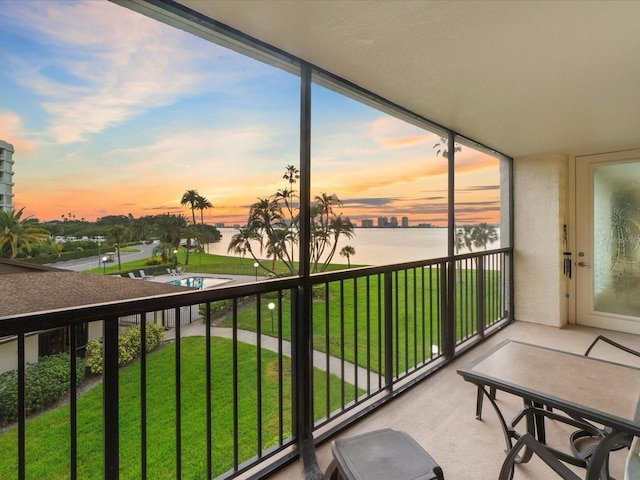 sunroom with a water view and a healthy amount of sunlight