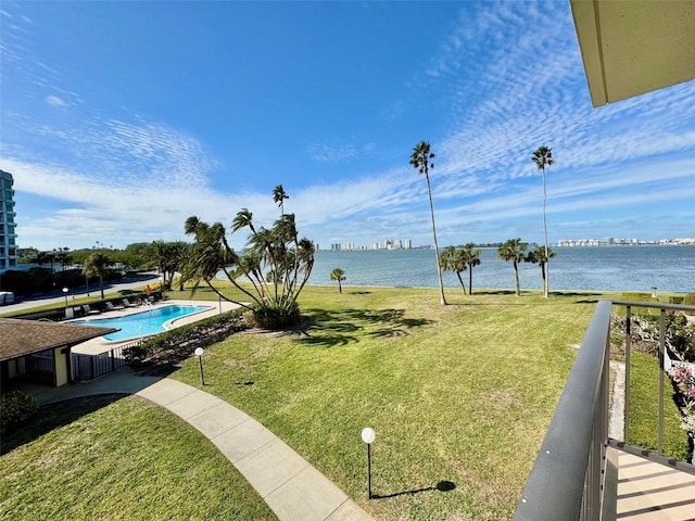 view of yard featuring a water view and a fenced in pool