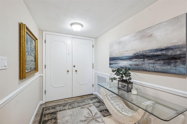 entryway with a textured ceiling