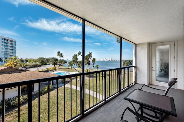 sunroom / solarium with a water view