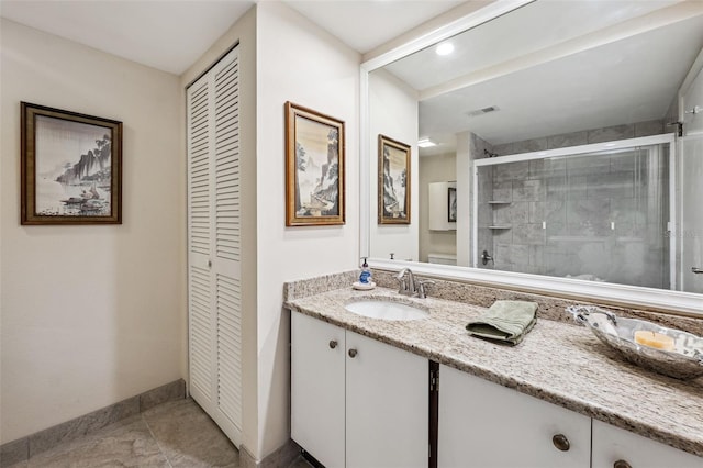 bathroom featuring vanity, a shower with door, and tile patterned flooring