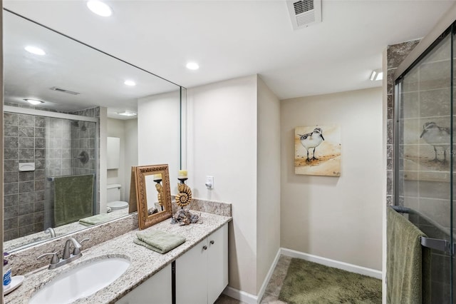 bathroom featuring walk in shower, vanity, and toilet