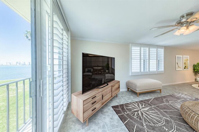 100 Oakmont Ln Unit 301, Belleair, FL 33756 - living room featuring a ceiling fan, light tile patterned floors, a water view, baseboards, and crown molding