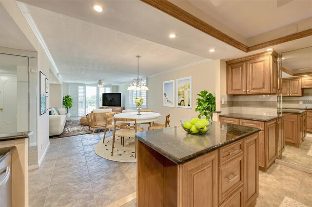 100 Oakmont Ln Unit 301, Belleair, FL 33756 - kitchen with a kitchen island, ornamental molding, open floor plan, decorative backsplash, and dark stone countertops