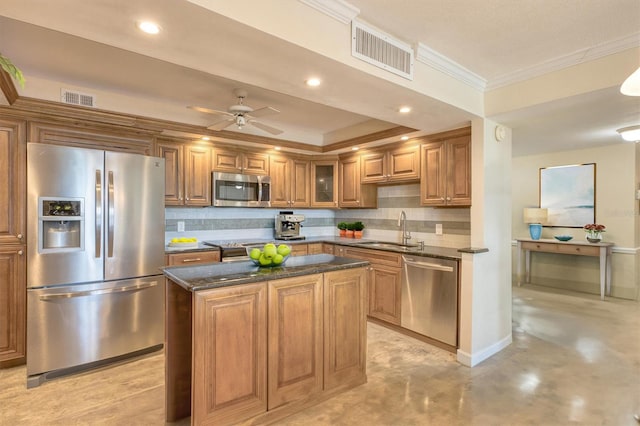 100 Oakmont Ln Unit 301, Belleair, FL 33756 - kitchen featuring stainless steel appliances, a sink, finished concrete floors, brown cabinets, and decorative backsplash