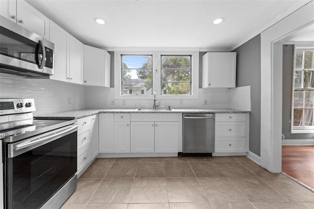 kitchen featuring stainless steel appliances, sink, plenty of natural light, and light hardwood / wood-style floors