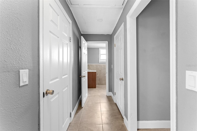 corridor featuring light tile patterned floors