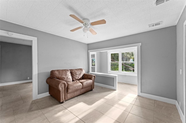 living room with ceiling fan and light tile patterned floors