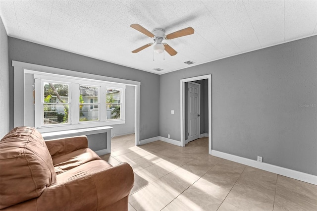 living room featuring light tile patterned flooring and ceiling fan