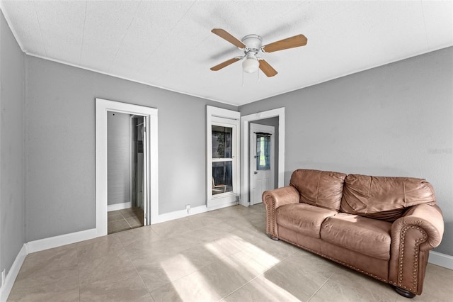 living room with ceiling fan and light tile patterned floors