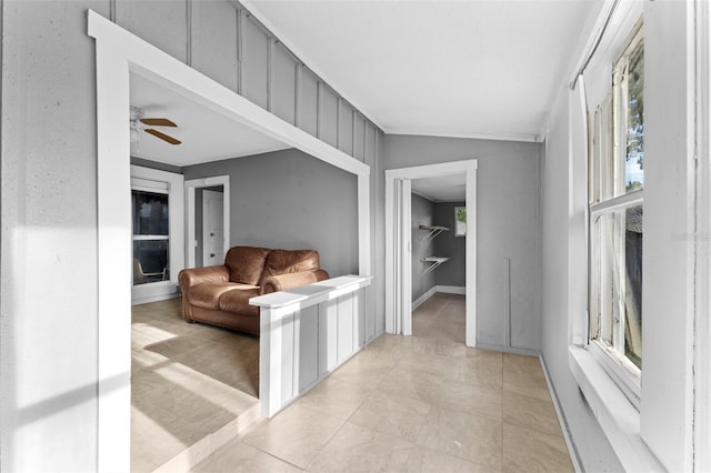 tiled living room with lofted ceiling, plenty of natural light, and ceiling fan