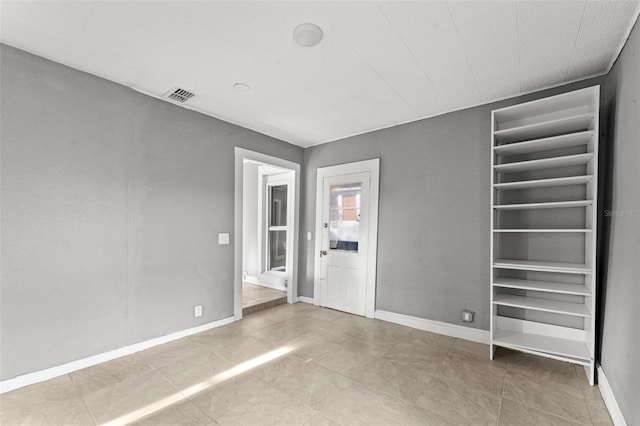 empty room featuring tile patterned floors