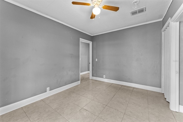 unfurnished bedroom with ceiling fan, light tile patterned floors, and crown molding