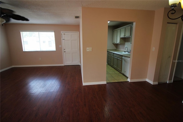 interior space featuring ceiling fan, dark tile patterned flooring, sink, and a textured ceiling