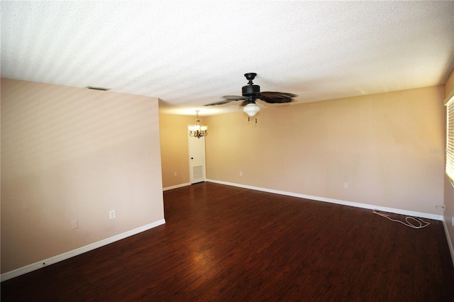 spare room featuring wood-type flooring, a notable chandelier, and a textured ceiling