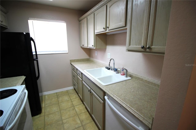 kitchen with light brown cabinets, stainless steel dishwasher, white stove, light tile patterned floors, and sink