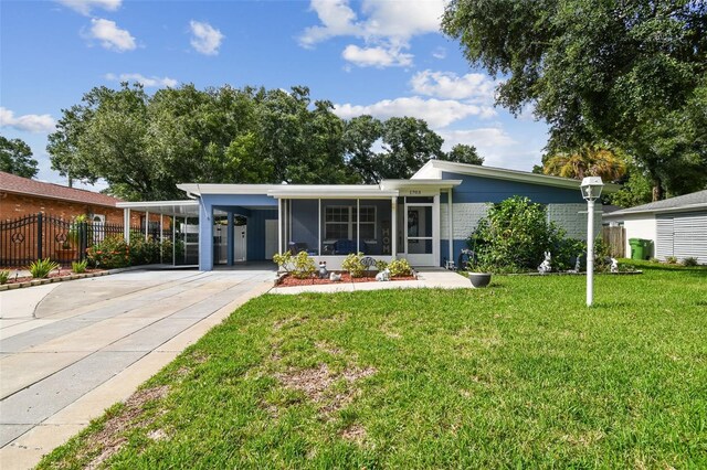 ranch-style home with a front yard and a carport