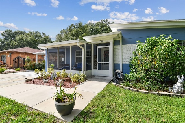 view of front of property with a front yard and a sunroom