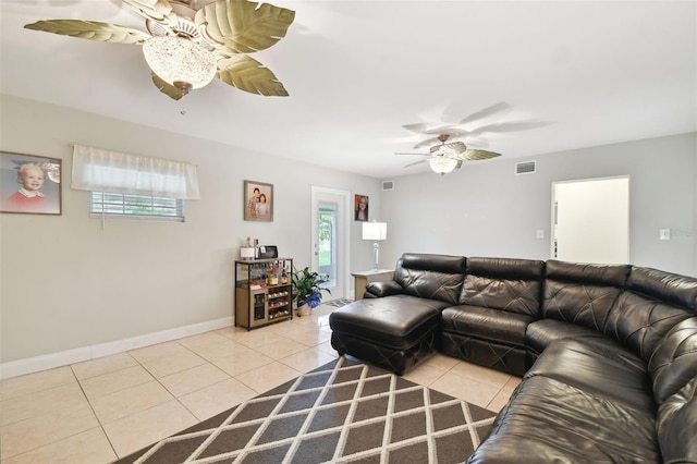 living room featuring ceiling fan, a wealth of natural light, and light tile patterned floors