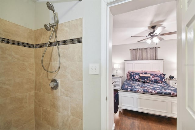 bathroom with ceiling fan, tiled shower, and wood-type flooring