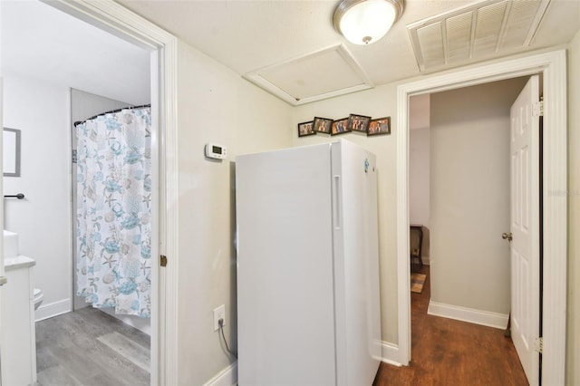 bathroom featuring walk in shower and wood-type flooring