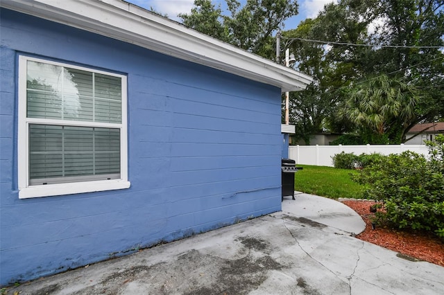 view of side of property featuring a yard and a patio area