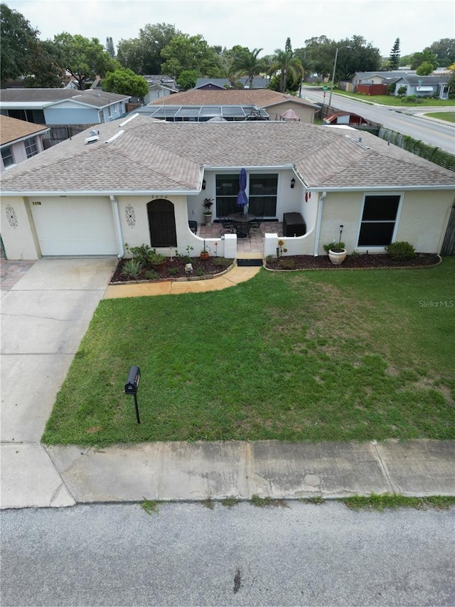 ranch-style house with a garage and a front yard