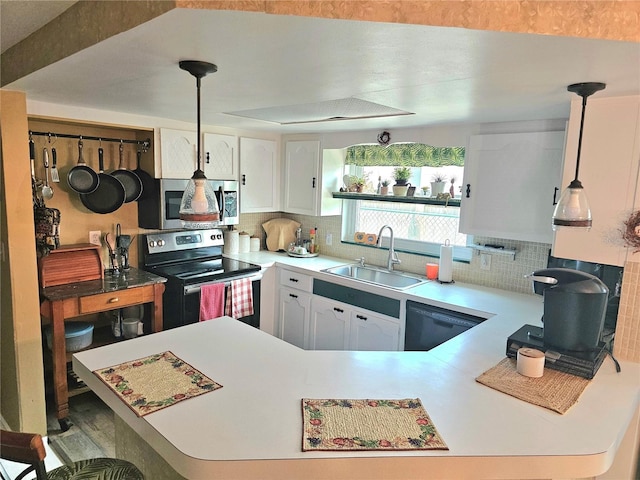 kitchen featuring stainless steel appliances, light countertops, a sink, and backsplash