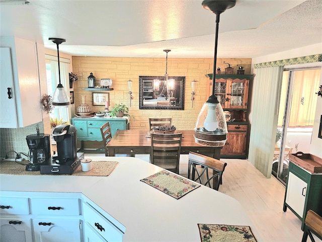 kitchen featuring a chandelier, pendant lighting, and wood finished floors