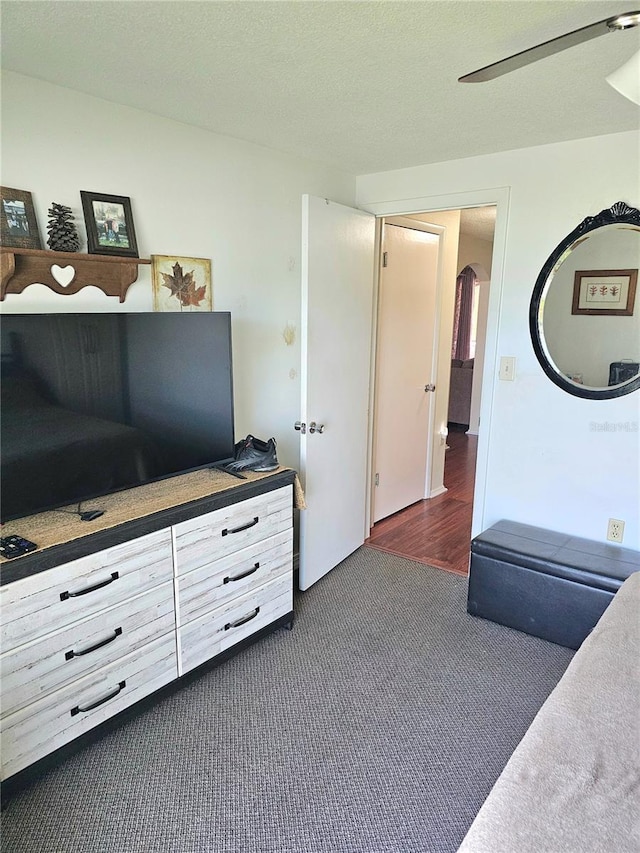 carpeted bedroom featuring a textured ceiling