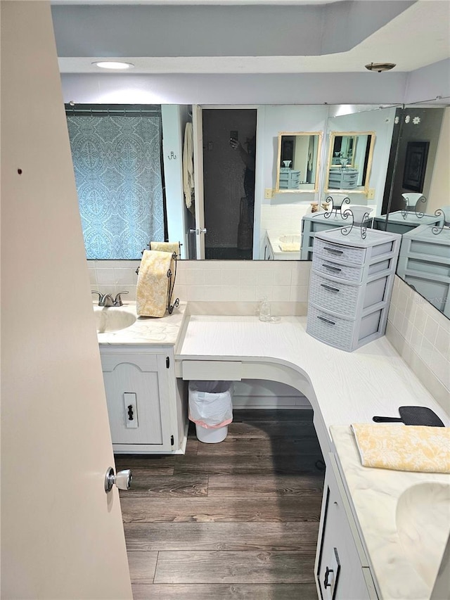 full bath featuring tasteful backsplash, wood finished floors, and vanity