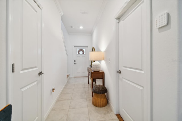 hall featuring light tile patterned floors and ornamental molding