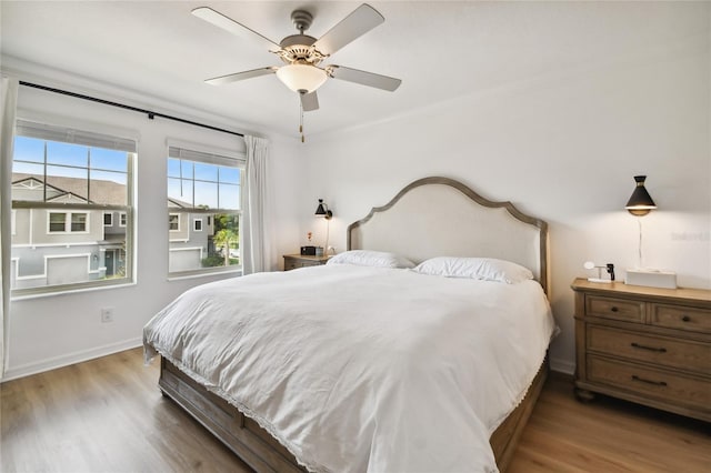 bedroom with ceiling fan and wood-type flooring