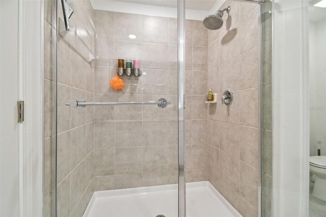 bathroom featuring walk in shower and toilet