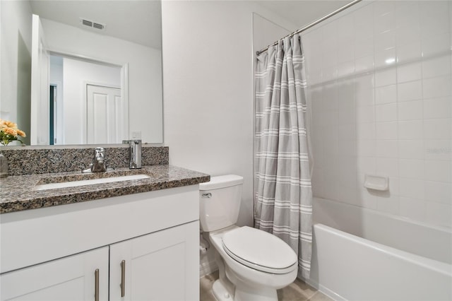 full bathroom with vanity, shower / tub combo, and toilet