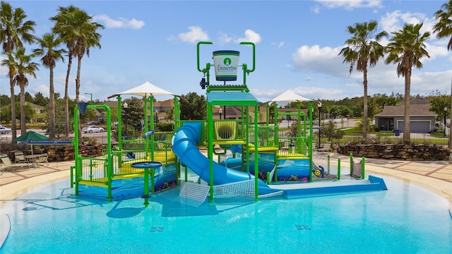 view of swimming pool with a playground