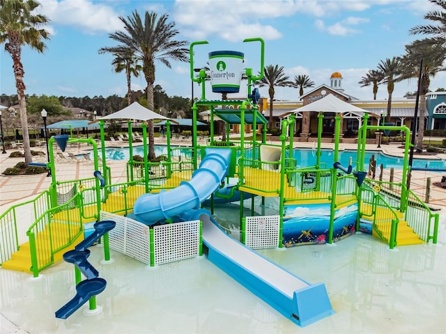 view of jungle gym with a community pool