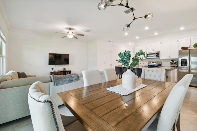 dining room featuring ornamental molding and ceiling fan