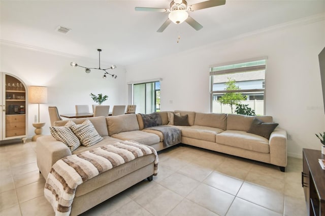 living room featuring crown molding, ceiling fan, and light tile patterned flooring