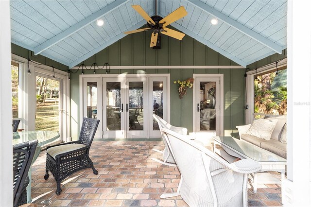 sunroom with ceiling fan, french doors, wood ceiling, and vaulted ceiling with beams