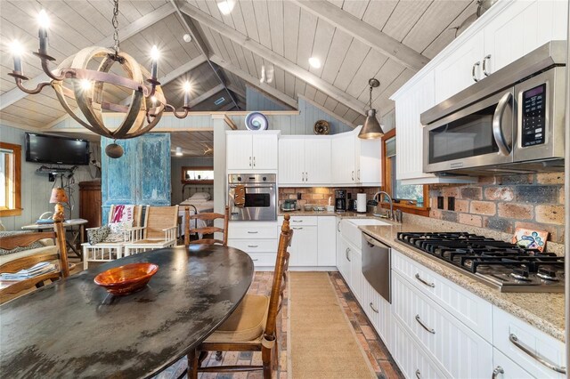 kitchen featuring stainless steel appliances, wood ceiling, light stone countertops, white cabinets, and sink