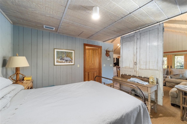 bedroom with wood walls and carpet