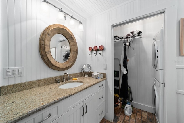 bathroom with vanity and stacked washing maching and dryer