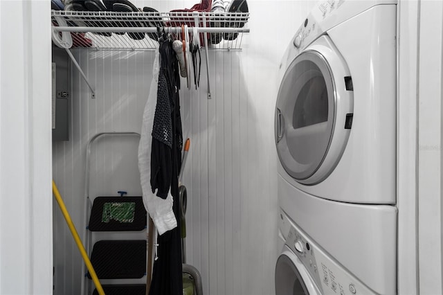 laundry room with stacked washer / dryer