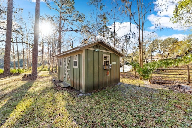 view of outbuilding featuring a yard