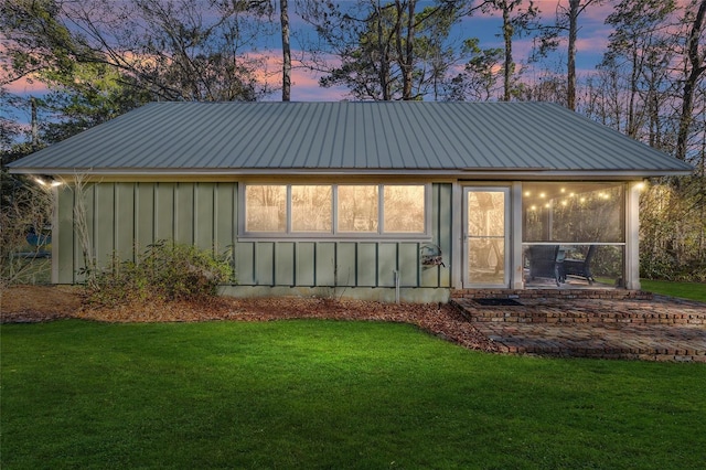 back house at dusk with a yard