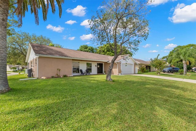 single story home with a garage and a front yard